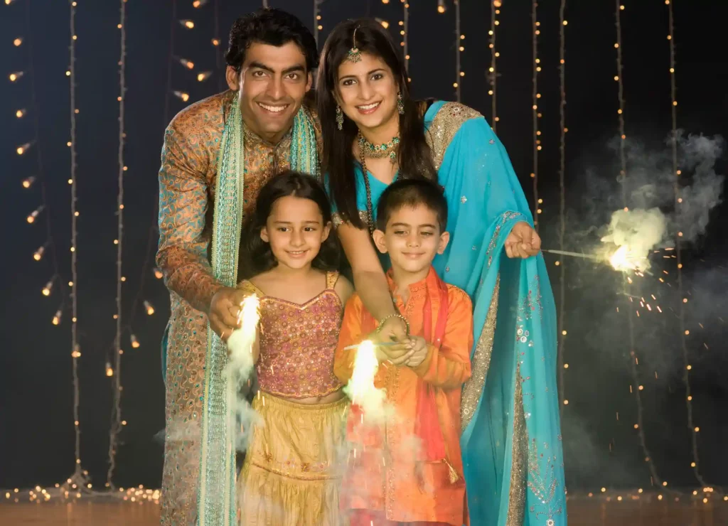 family celebrating diwali with sparklers