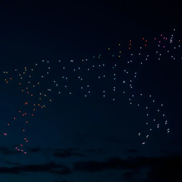 drones vs fireworks - drones in night sky creating the image of a horse