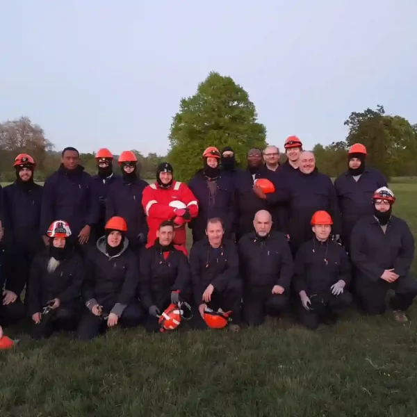 group of people at experience day at completion wearing red hard hats and PPE